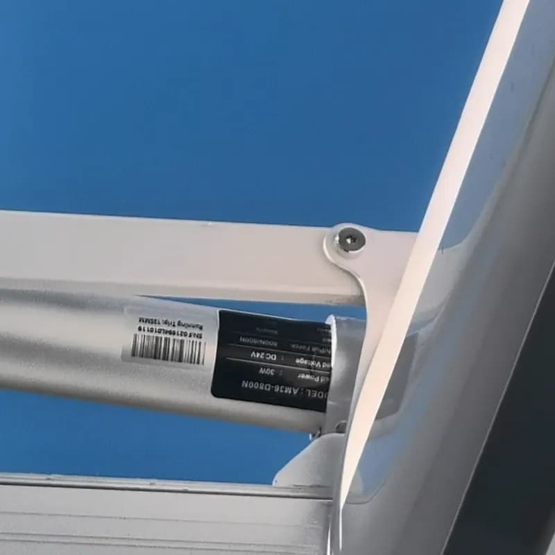 The louvre motor mounted inside the white aluminium frame