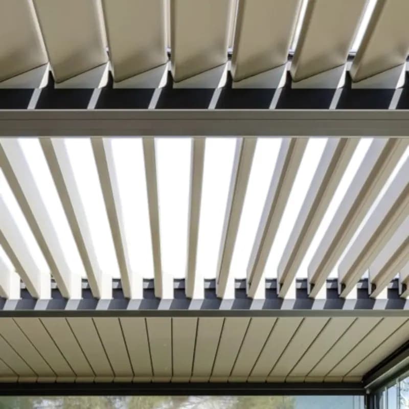 Looking up through white aluminium louvres tilted open towards the sky